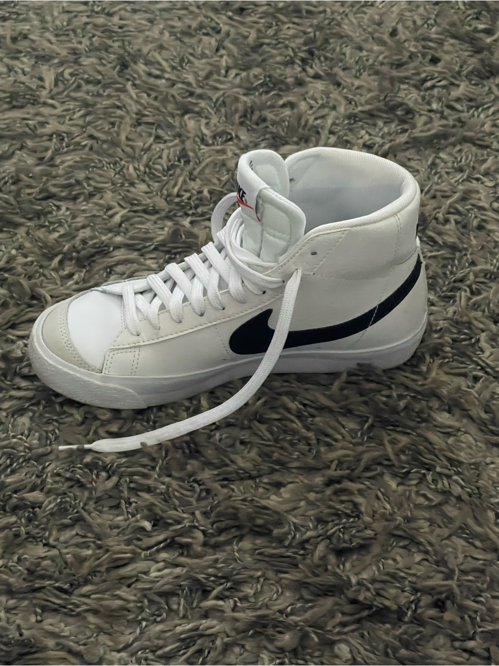 Nike White High-Top Sneakers with Black Swoosh